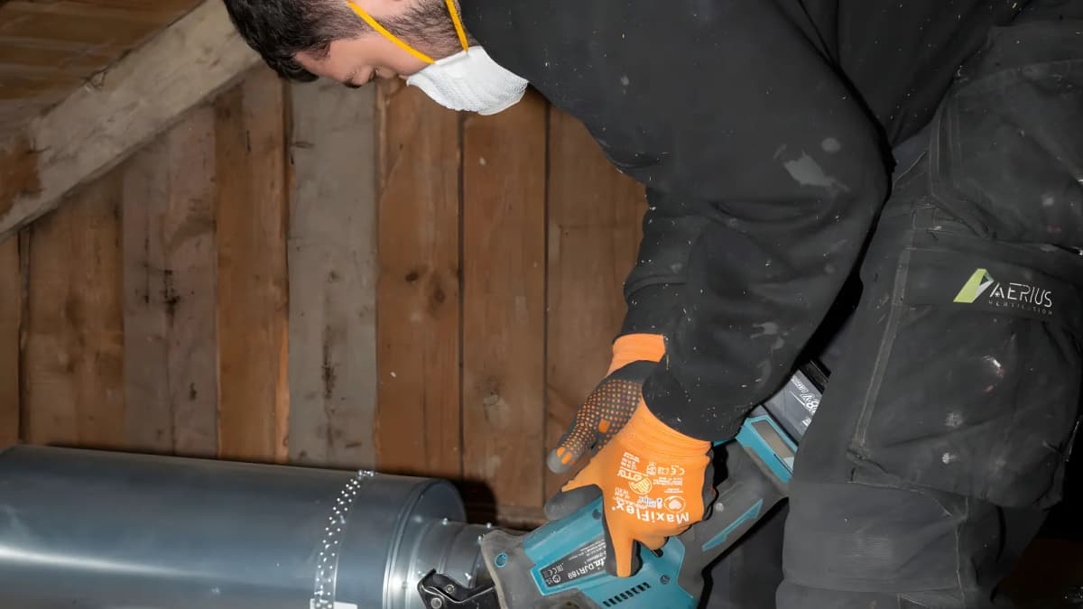 Tekniker som arbetar med fläkt och kanaler för mekanisk frånluft